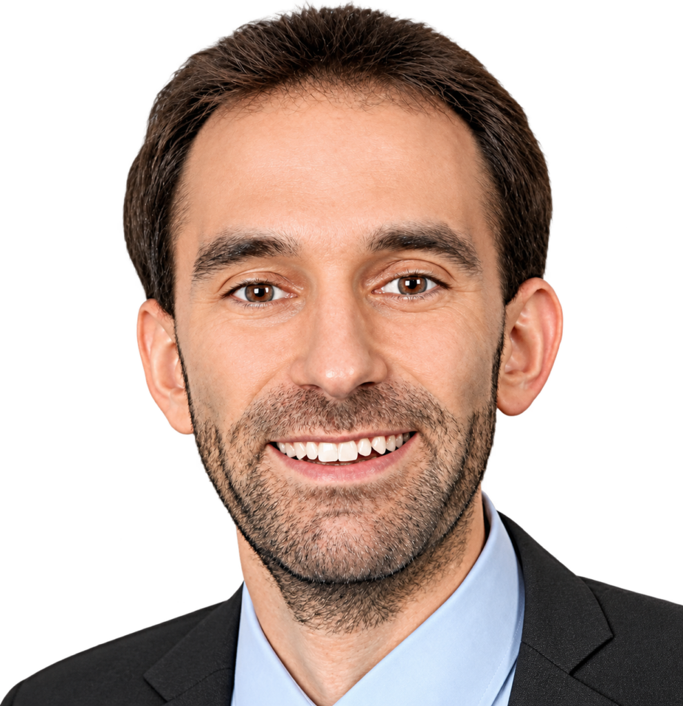 Team member headshot, smiling man in a blue shirt