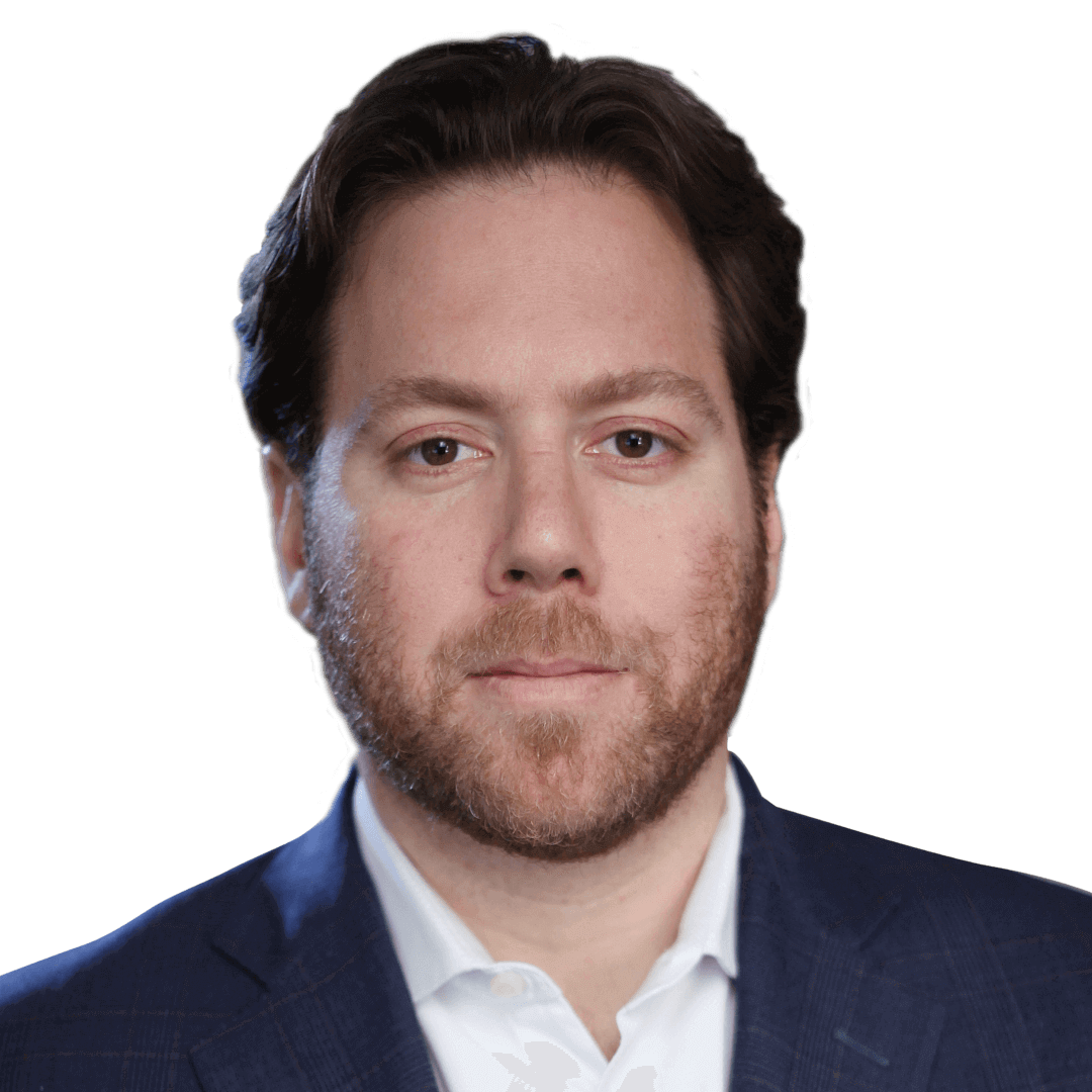 Team member headshot, man with a beard in a dark suit